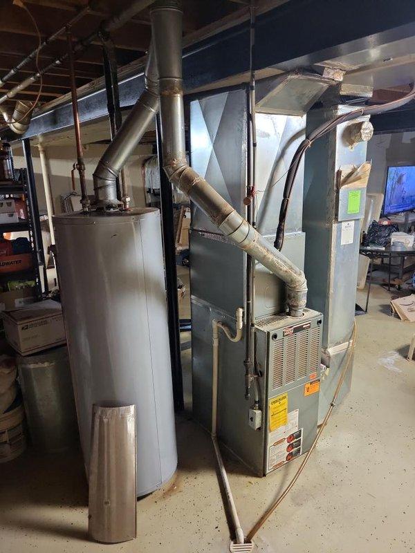 Completed comprehensive estimate for replacement of 30-year-old basement furnace unit showing signs of deterioration including inducer motor patched with silicone. Homeowner reported concerns regarding increased gas bills and indoor air quality issues related to smoke odors transferring through the HVAC system. Recommended installation of i-wave or APCO air purification system to address air quality concerns in addition to furnace replacement to improve efficiency and resolve safety issues with aging equipment.