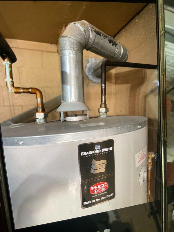 Completed comprehensive city certification inspection on 5-year-old HVAC system located in utility room. Performed thorough tune-up including inspection of gas furnace with operational burner verification, thermostat calibration check, humidifier assessment, and Bradford White water heater examination. All components found operating within normal parameters with burners igniting properly and exhibiting proper blue flame combustion, exhaust venting secure, and water connections intact.