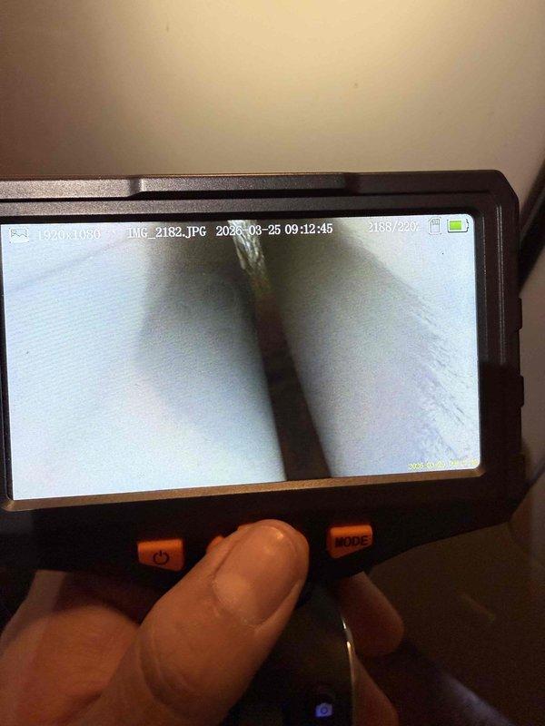 Responded to service call for furnace producing humming noise in condo unit. Performed diagnostic inspection on furnace system over 10 years old located near kitchen area. Utilized borescope camera equipment to conduct internal visual inspection of ductwork and confined system components to identify source of abnormal operational sounds and assess overall equipment condition.