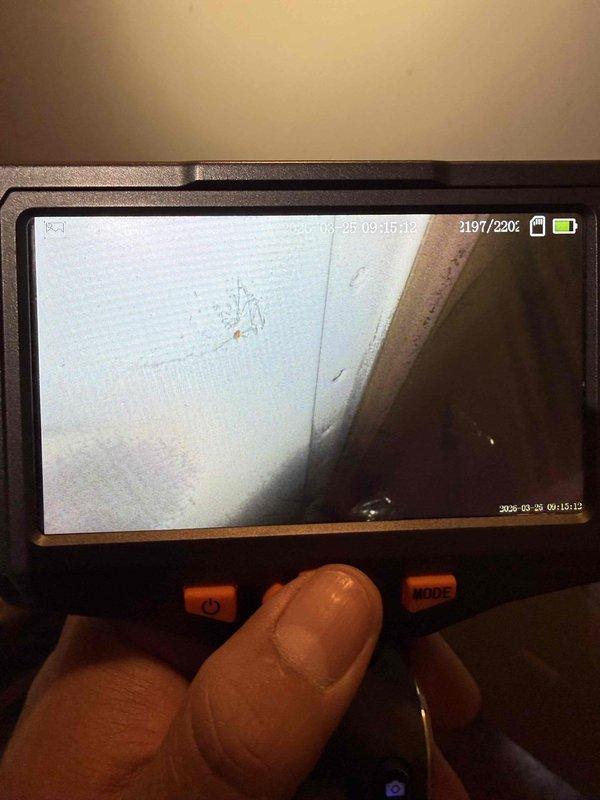 Responded to service call for furnace producing humming noise in condo unit. Performed diagnostic inspection on furnace system over 10 years old located near kitchen area. Utilized borescope camera equipment to conduct internal visual inspection of ductwork and confined system components to identify source of abnormal operational sounds and assess overall equipment condition.