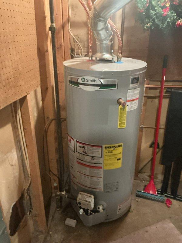 Responded to hot water delivery issue affecting specific area of residence that had persisted for approximately two weeks. Accessed AO Smith tanked water heater located in crawlspace beneath home. Inspected unit and associated plumbing connections, including copper supply lines with corrugated flexible connectors and exhaust venting system. Documented existing installation conditions with photographs showing water heater configuration, piping connections, and surrounding utility space layout. Evaluated system performance and identified cause of localized hot water deficiency in older residential plumbing system.