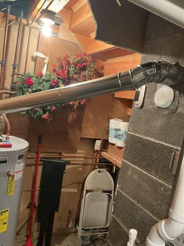 Responded to hot water delivery issue affecting specific area of residence that had persisted for approximately two weeks. Accessed AO Smith tanked water heater located in crawlspace beneath home. Inspected unit and associated plumbing connections, including copper supply lines with corrugated flexible connectors and exhaust venting system. Documented existing installation conditions with photographs showing water heater configuration, piping connections, and surrounding utility space layout. Evaluated system performance and identified cause of localized hot water deficiency in older residential plumbing system.