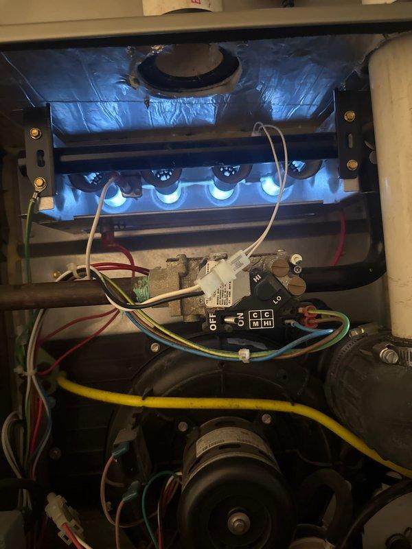 Completed comprehensive tune-up and city inspection preparation on 8-10 year old gas furnace located in basement. Performed full system evaluation including burner assembly operation verification, heat exchanger inspection, blower motor assessment, electrical connection testing, and ductwork examination. All components found operating within normal parameters with burner flames showing proper blue combustion pattern and system controls functioning correctly.