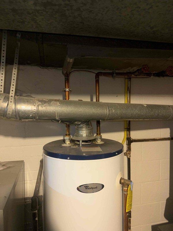 Completed comprehensive tune-up and safety inspection on furnace over 10 years old located in basement for city inspection compliance. Verified proper ignition sequence and burner flame characteristics, confirmed all gas connections secure with no leaks detected, and inspected heat exchanger for integrity. Tested all safety controls including limit switches and flame sensor, cleaned burner assembly, checked and adjusted gas pressure, and verified proper venting and combustion air supply. System operating safely and efficiently within manufacturer specifications; all components functioning properly with no immediate concerns noted.