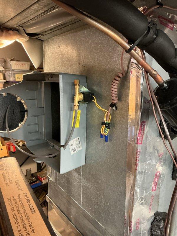 Installed Aprilaire small by-pass humidifier model 313 on existing HVAC system. Connected humidifier to ductwork with proper supply and return air routing, installed humidistat control wiring to furnace control board, and plumbed water supply line with saddle valve connection. Verified all electrical connections at control board, tested humidifier operation, and confirmed proper system integration with heating equipment.