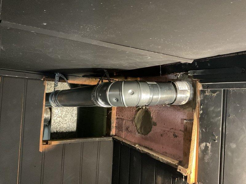 Completed installation and venting work for water heater using chimney liner system. Installed metallic ductwork including smooth rigid piping and corrugated flexible venting to properly exhaust combustion gases through existing chimney structure. Secured all ductwork with appropriate metal straps and hangers to ceiling joists, ensuring proper support and code-compliant clearances. Verified proper draft and ventilation for safe water heater operation.