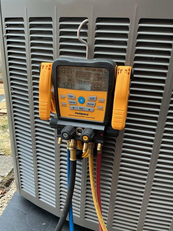 Completed full HVAC system installation including a 70,000 BTU furnace, 2.5-ton rear-discharge air conditioning unit, humidifier, and hot water heater. Installed S40 thermostat, performed all necessary mechanical and electrical connections, and reconnected existing equipment. Applied for mechanical and electrical permits prior to installation. Added condensate pump, installed chimney liner for proper venting, and completed all refrigerant line connections. Performed vacuum test and pressure checks using digital manifold gauges to verify system integrity and proper refrigerant charge. System tested and operational, qualifying for utility rebate program with AHRI certificate number 215663885.