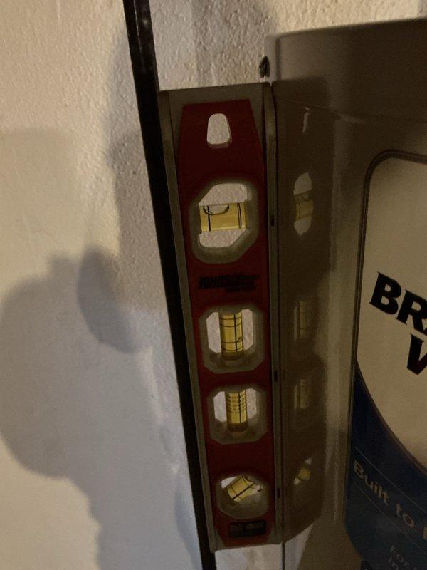 Responded to callback for water heater leak following previous day's installation of furnace and Bradford White water heater. Upon arrival, found active leak at inlet fixture connection entering wall, resulting in standing water around unit and no hot water availability. Inspected installation, verified water heater level and plumbing connections, tightened fixture connection at wall penetration point, and resolved leak. Confirmed proper operation and hot water restoration before departure.