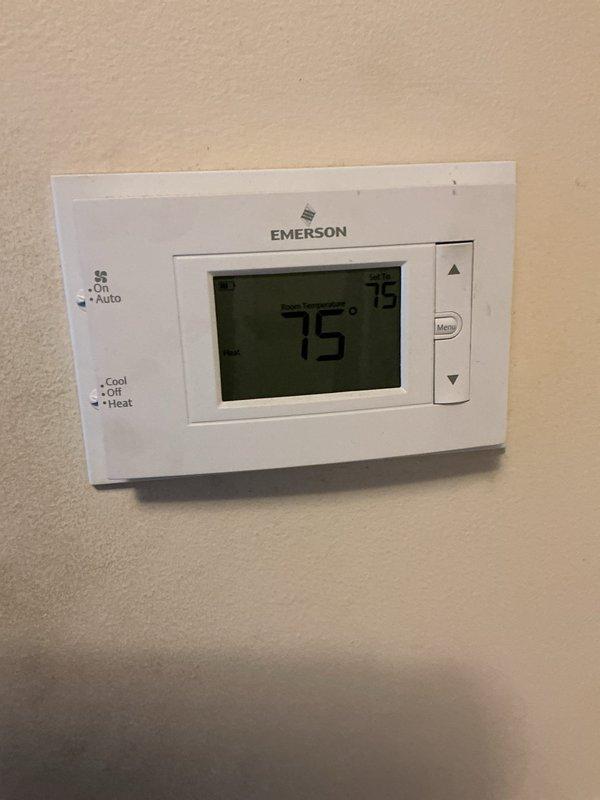 Completed comprehensive Gold-level furnace inspection on a 2-year-old forced air system located in the basement. Verified thermostat operation showing proper temperature control at 75°F with heating mode functional. Inspected all mechanical components including air handler, refrigerant lines, copper piping connections, brass fittings and valves, electrical connections, and condensate drainage system. All equipment found operating within normal parameters with no deficiencies noted. System confirmed to be in good working condition with proper airflow and no safety concerns identified.