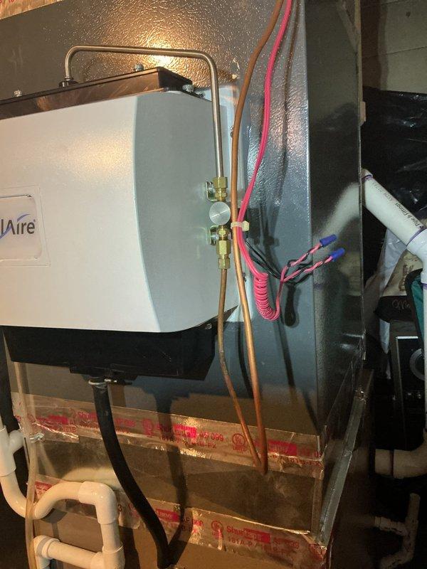 Completed comprehensive Gold-level furnace inspection on a 2-year-old forced air system located in the basement. Verified thermostat operation showing proper temperature control at 75°F with heating mode functional. Inspected all mechanical components including air handler, refrigerant lines, copper piping connections, brass fittings and valves, electrical connections, and condensate drainage system. All equipment found operating within normal parameters with no deficiencies noted. System confirmed to be in good working condition with proper airflow and no safety concerns identified.