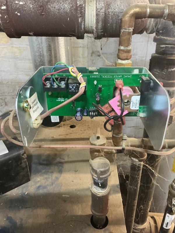 Responded to service call for leaking radiator in back room connected to 10-year-old steam boiler system located in basement. Performed diagnostic inspection of steam distribution system, identifying leak source at radiator connection point. Inspected boiler control board, pressure relief components, and steam piping infrastructure for proper operation and potential contributing factors to the leak condition.