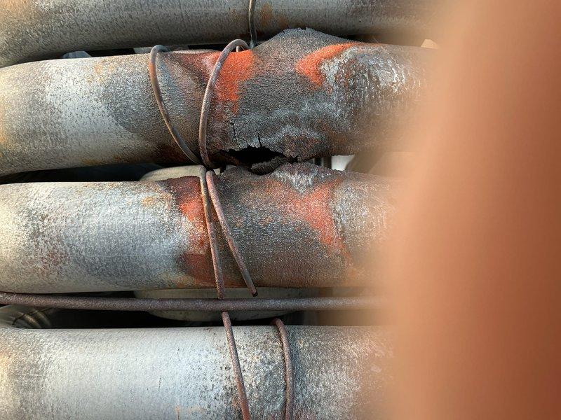 Returned to site with replacement fuses for rooftop unit. Restored power to RTU and performed complete combustion analysis and thorough visual inspection of heat exchanger. During inspection, observed significant frost accumulation on refrigerant lines indicating potential system issues. Documented extensive ice buildup on insulated piping with visible rust staining on pipe insulation. Verified proper operation of heating components and confirmed heat exchanger passed visual inspection with no cracks or deterioration detected. Combustion analysis results within acceptable parameters. Unit left operational with power restored. Photographed refrigerant line conditions showing heavy frost formation on multiple parallel pipes, which may require future attention for possible refrigerant flow restrictions or insulation concerns.