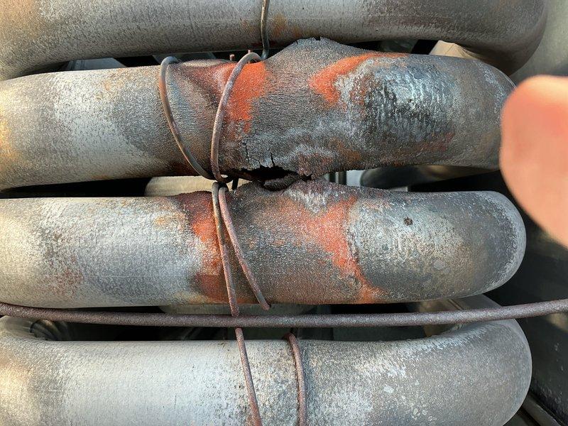 Returned to site with replacement fuses for rooftop unit. Restored power to RTU and performed complete combustion analysis and thorough visual inspection of heat exchanger. During inspection, observed significant frost accumulation on refrigerant lines indicating potential system issues. Documented extensive ice buildup on insulated piping with visible rust staining on pipe insulation. Verified proper operation of heating components and confirmed heat exchanger passed visual inspection with no cracks or deterioration detected. Combustion analysis results within acceptable parameters. Unit left operational with power restored. Photographed refrigerant line conditions showing heavy frost formation on multiple parallel pipes, which may require future attention for possible refrigerant flow restrictions or insulation concerns.