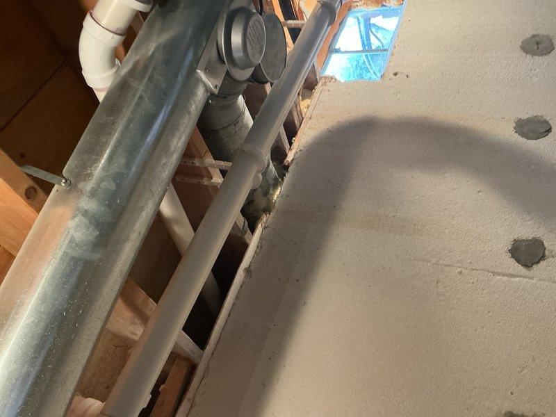 Completed hot water tank venting repair in residential property. Installed new PVC venting system through attic space to ensure proper exhaust ventilation and compliance with safety codes. Secured all ductwork and piping, verified proper clearances from combustible materials, and confirmed system operates within manufacturer specifications.