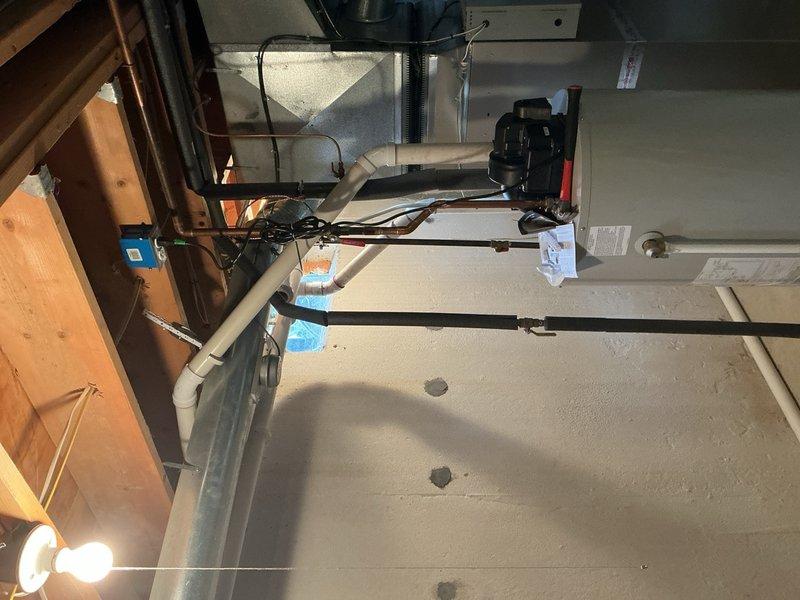 Completed hot water tank venting repair in residential property. Installed new PVC venting system through attic space to ensure proper exhaust ventilation and compliance with safety codes. Secured all ductwork and piping, verified proper clearances from combustible materials, and confirmed system operates within manufacturer specifications.