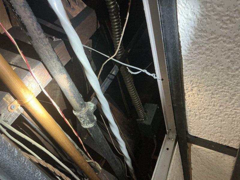 Conducted on-site assessment for gas line replacement in garage area. Inspected existing copper gas piping running along overhead structure near garage door mechanism and evaluated current routing and condition. Documented installation area including cabinet enclosure with prepared penetration for gas line routing. Provided comprehensive estimate for complete gas line replacement work including materials and labor required for safe installation per code requirements.