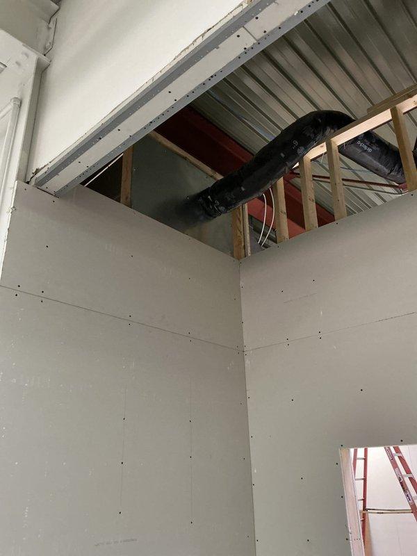 Completed time and material ductwork installation at commercial facility. Installed flexible HVAC ductwork through ceiling space with proper support and routing, coordinated with existing structural framing and roof deck. Integrated metallic ductwork system with new drywall ceiling installation, ensuring proper clearances and access for future maintenance.