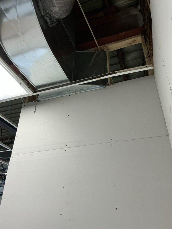 Completed time and material ductwork installation at commercial facility. Installed flexible HVAC ductwork through ceiling space with proper support and routing, coordinated with existing structural framing and roof deck. Integrated metallic ductwork system with new drywall ceiling installation, ensuring proper clearances and access for future maintenance.