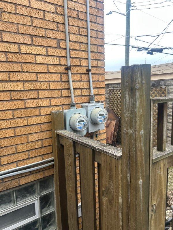 Completed installation of 70,000 BTU furnace system including mechanical and electrical connections, liner installation, and reconnection of existing components. Obtained required mechanical and electrical permits prior to installation, and system qualified for utility rebate program. Exterior venting and electrical work completed with proper PVC pipe configuration and conduit installation visible on building exterior.