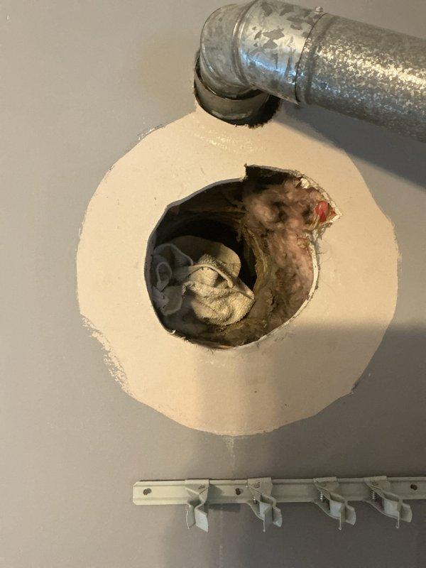 Responded to emergency service call for furnace with compromised exhaust venting system. Upon inspection, discovered significant rust deterioration on metal venting pipe connected to furnace, resulting in a breach that posed carbon monoxide hazard. Furnace was immediately shut down to prevent dangerous exhaust fumes from entering living space. Documented existing conditions with photographs showing the deteriorated ductwork elbow fitting at ceiling penetration point and overall mechanical room configuration including water heater, furnace unit, and associated plumbing components. Advised customer of safety concerns and recommended immediate venting system replacement before furnace could be safely returned to operation.