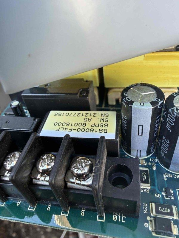 Responded to service call for Briggs and Stratton 12kW standby generator displaying speed sensor error code. Accessed internal control panel and inspected electronic control board assembly, capacitors, and sensor connections. Documented circuit board condition including terminal blocks, capacitor bank, and control module (model B816000-F-ALP) for warranty verification purposes.