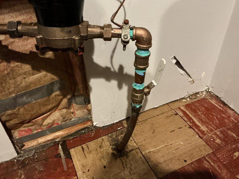 Responded to emergency water leak in main line located in basement of 1952-built home. Upon arrival, shut off water supply from exterior shutoff valve to prevent further water damage. Identified active leak in corroded main water line piping system, which had been leaking for approximately two days prior to service call.

Removed deteriorated section of main line piping and installed new brass valve assembly with copper pipe connections. Utilized compression fittings with corrosion-resistant seals at joint connections to ensure watertight installation. Secured new piping to existing wall structure and verified proper alignment with existing plumbing infrastructure.

Restored water supply and pressure-tested entire main line system to confirm leak elimination and verify integrity of new installation. Monitored connections for several minutes under full pressure to ensure no weeping or seepage at joints. Confirmed proper water flow throughout home and verified all fixtures operational. L