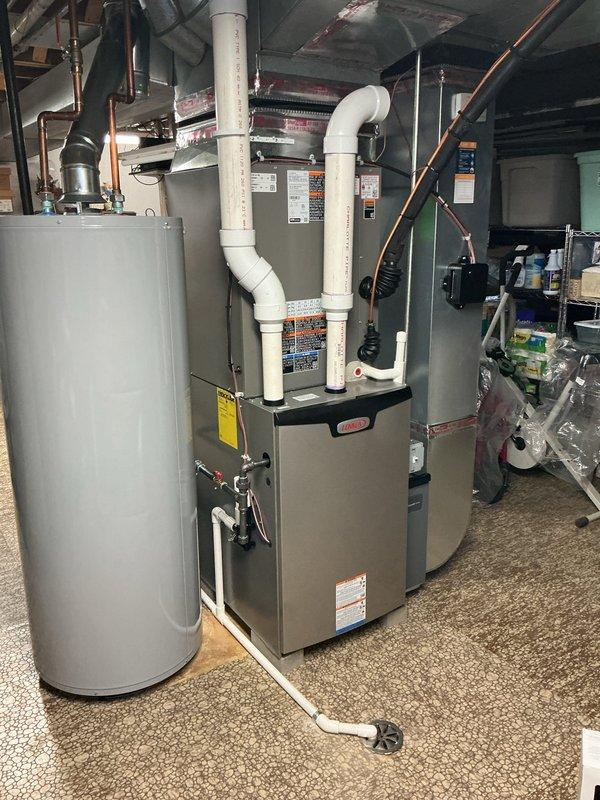 Completed Gold Furnace Inspection on 8-month-old Lennox furnace located in basement. Unit was operational but customer reported leak caused by loose screws following previous inspection. Tightened all mounting screws and fasteners to manufacturer specifications, inspected PVC condensate drain lines and exhaust venting for proper installation and secure connections, and verified all panel attachments. Tested system operation, confirmed no active leaks present, and validated proper thermostat communication with heating equipment.