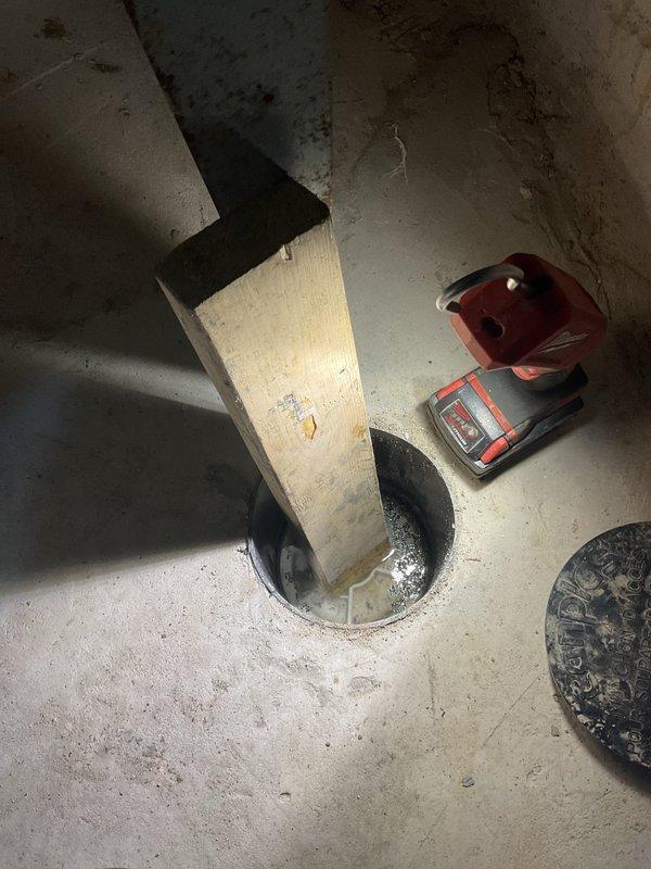 Completed callback service for basement toilet bubbling issue following previous floor break and excavation work. Inspected sump pit installation and drainage system components to verify proper operation after recent repair work. Documented completed installation with photos showing finished concrete floor opening, drainage basin, and associated plumbing fixtures in working condition.