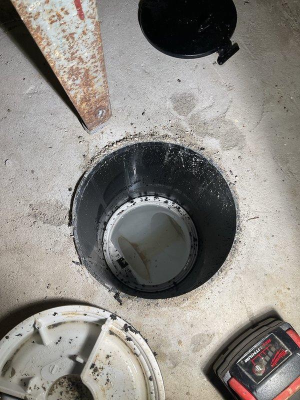 Completed callback service for basement toilet bubbling issue following previous floor break and excavation work. Inspected sump pit installation and drainage system components to verify proper operation after recent repair work. Documented completed installation with photos showing finished concrete floor opening, drainage basin, and associated plumbing fixtures in working condition.