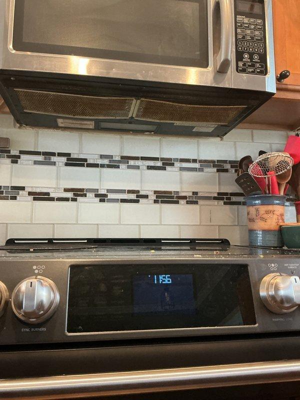 Performed diagnostic evaluation of over-the-range microwave ventilation system in kitchen. Found unit operating in recirculation mode with exhaust air venting back into space behind microwave rather than being properly ducted to building exterior through available exterior wall. Assessed existing installation configuration, cabinet arrangement, and potential exterior venting pathway to provide recommendations for converting recirculating system to proper exterior exhaust ventilation.