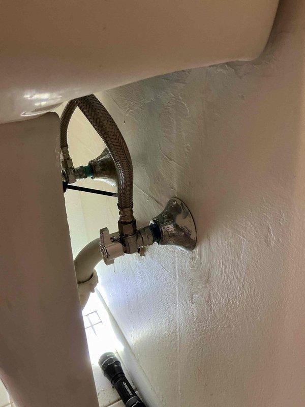 Responded to low water pressure complaint at residential property. Upon inspection, identified compromised angle stop valve and aging braided flexible supply line serving toilet fixture. Replaced defective angle stop valve with new quarter-turn shut-off valve to restore proper water flow control. Installed new braided stainless steel flexible connector to ensure reliable water delivery to fixture. Tested system under full pressure, confirmed adequate water flow restored to normal operating parameters, and verified no leaks at connections. System returned to full functionality.