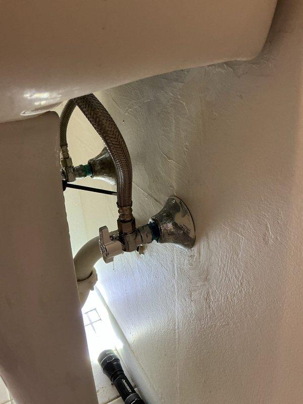 Responded to low water pressure complaint at residential property. Upon inspection, identified compromised angle stop valve and aging braided flexible supply line serving toilet fixture. Replaced defective angle stop valve with new quarter-turn shut-off valve to restore proper water flow control. Installed new braided stainless steel flexible connector to ensure reliable water delivery to fixture. Tested system under full pressure, confirmed adequate water flow restored to normal operating parameters, and verified no leaks at connections. System returned to full functionality.