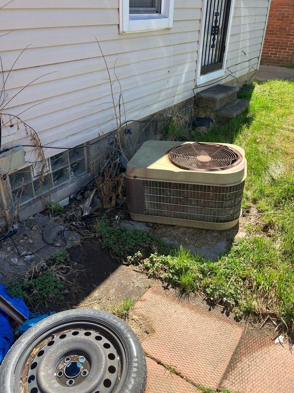 Conducted on-site evaluation and generated replacement estimate for non-operational central air conditioning unit and aging furnace system. Assessed exterior condenser unit showing significant weathering and potential mechanical failure, along with basement-located furnace equipment. Documented existing system conditions through photographic evidence, noting deteriorated outdoor unit placement, overgrown surrounding area, and accumulated debris near foundation. Provided comprehensive replacement recommendations for both heating and cooling equipment to restore full HVAC system functionality.