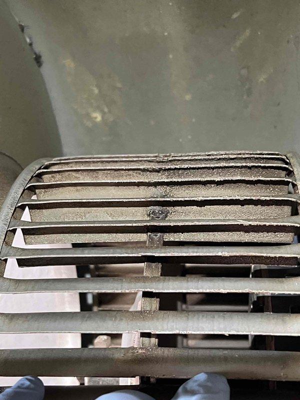 Responded to service call for 10+ year old furnace in basement experiencing unusual noises and inadequate heating. Performed diagnostic inspection revealing heavily contaminated return air grille with significant dust and debris accumulation restricting airflow. Examined control board (HK42FZ0172806) for potential electronic component failure or malfunction related to reported operational issues. Identified need for system cleaning and further evaluation of heating performance after airflow restoration.