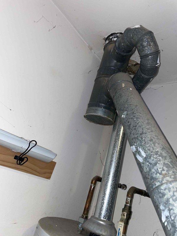 Provided estimate for replacement of 20-year-old natural gas furnace located in basement. Assessed existing equipment condition, noting moisture accumulation on ductwork and galvanized piping, and documented current system configuration including ventilation components and mounting locations for new installation planning.