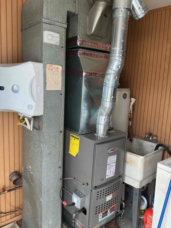 Installed a Lennox 70,000 BTU furnace in residential utility room with new B-vent stack system. Integrated humidifier unit and reconnected all electrical and gas connections to manufacturer specifications. Requested mechanical and electrical permits for installation, documented equipment placement and verified proper operation of all systems.