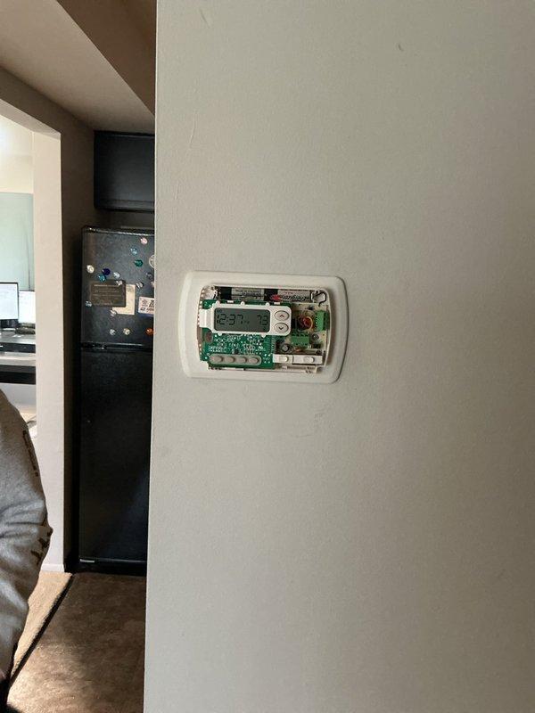 Responded to service call for electric furnace continuously running and unable to shut off without breaker intervention. Upon arrival, inspected thermostat and found faulty relay causing the heating system to remain energized regardless of temperature setpoint. Removed thermostat cover to examine internal circuit board and wiring connections. Identified malfunctioning control board preventing proper communication between thermostat and furnace unit. Temporarily disabled power at electrical panel to safely assess system. Verified furnace located in common storage area was still producing heat due to stuck relay contacts. Recommended thermostat replacement to restore proper system cycling and prevent continuous operation.