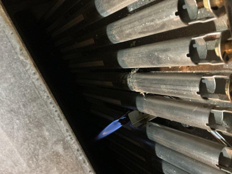 Responded to no heat call on 14-year-old boiler located in basement. Upon arrival, confirmed unit was receiving power and control components were energizing, but boiler failed to ignite. Performed diagnostic testing using multimeter, measuring 15.5 volts at critical circuit points. Inspected heat exchanger assembly, which showed significant dust accumulation, discoloration, and minor corrosion on metallic fins and surfaces. Identified ignition failure as primary issue preventing burner from firing. Cleaned heat exchanger components and addressed ignition system malfunction to restore proper operation and heating functionality to the residence.