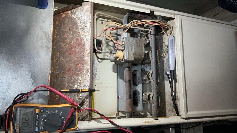 Responded to service call for furnace with pilot ignition failure on unit over 20 years old located in furnace closet. Performed diagnostic testing using multimeter to check electrical components and circuits. Found significant corrosion on access panel and interior components, with heavy dust accumulation throughout system affecting operation. Tested blower motor assembly, heat exchanger, and burner assembly connections. Identified failed ignition system components preventing pilot from lighting. Unit showed advanced age-related deterioration with moisture damage and oxidation on metal surfaces. Recommended replacement due to extensive corrosion, failed ignition components, and overall system condition exceeding serviceable lifespan.