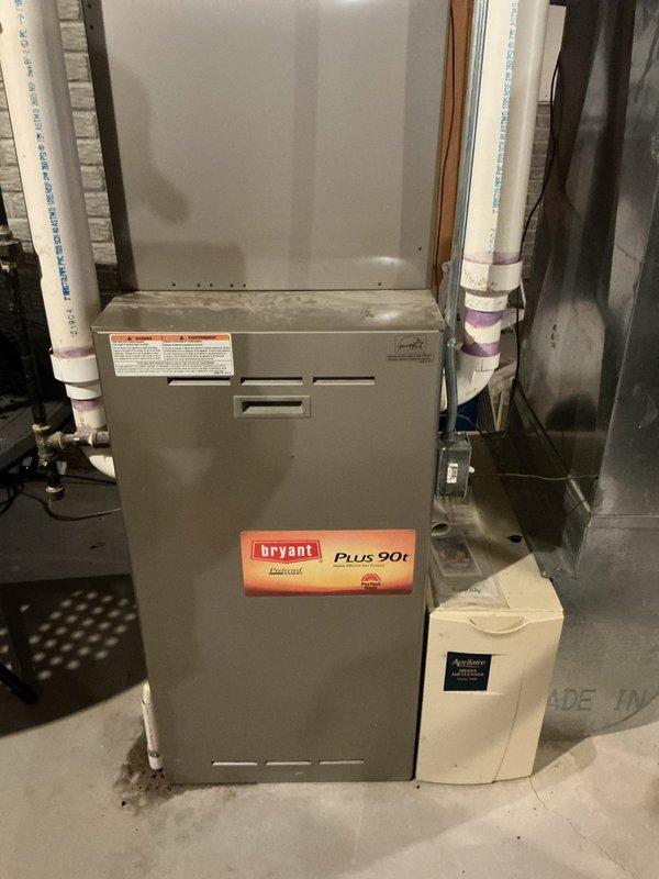 Responded to service call for Bryant Plus 90t furnace in basement unable to maintain setpoint temperature of 71 degrees, with actual temperature remaining at 65-67 degrees. Performed diagnostic evaluation of 3-4 year old unit and examined thermostat operation, air distribution system, and ductwork configuration. Inspected furnace cabinet, condensate drain lines, PVC venting system, and heat exchanger for proper operation. Verified gas supply, ignition sequence, and burner performance. Checked blower motor operation, air filter condition, and airflow throughout the system. Evaluated zone control system interaction with two other furnaces on property to determine if compensation from other units was masking heating deficiency. Assessed duct system for proper sizing, airflow restrictions, and potential heat loss issues affecting lower level temperature maintenance.