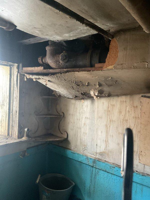 Responded to a service call for a toilet leak in the bathroom. Upon inspection, removed the tank lid and found extensive rust staining and corrosion throughout the tank interior, affecting the flush valve assembly and metal mounting components. The water exhibited brownish discoloration indicating deteriorated internal parts and hard water deposits. Diagnosed the leak source related to compromised seals and corroded hardware within the tank mechanism. Assessed the overall condition of the fixture and provided recommendations for repair or replacement based on the severity of corrosion present in the flushing system components.