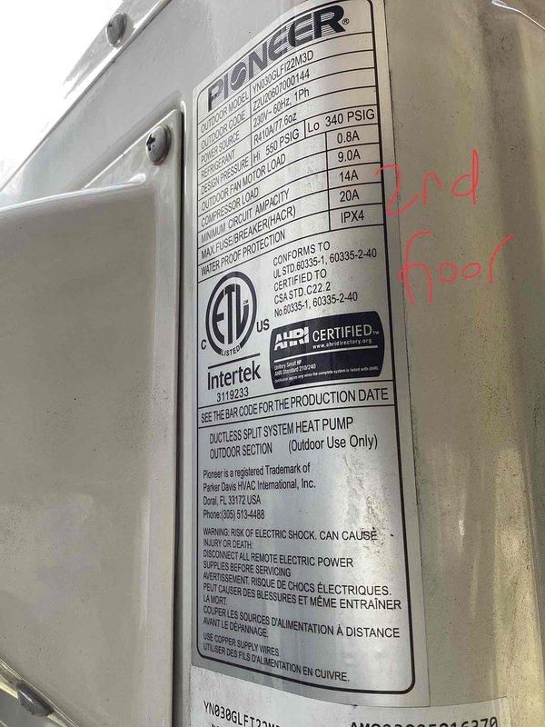 Performed estimate for residential ductless mini-split heat pump system with two units installed by non-professional, resulting in code violations and equipment failure. Assessed lower unit with suspected compressor failure as priority for replacement, while upper unit remains operational. Documented Pioneer brand outdoor condensers mounted on exterior wall with interconnecting refrigerant lines and drainage piping, identifying 3-year-old and less-than-1-year-old systems requiring remediation to meet code compliance.