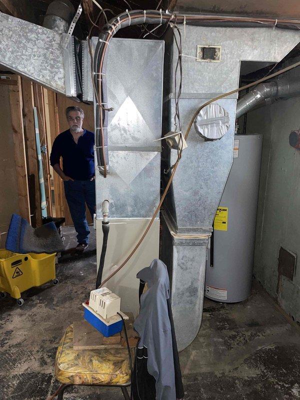 Performed comprehensive diagnostic evaluation on 20-year-old furnace system located in basement that was not operational. Inspection revealed multiple critical failures including several cracks in the heat exchanger, blower motor with oil leakage, and failed gas valve. Due to the age of the equipment and severity of the compromised components, particularly the cracked heat exchanger which poses safety concerns, provided estimate for complete furnace replacement system. Thermostat confirmed operational with proper power supply.