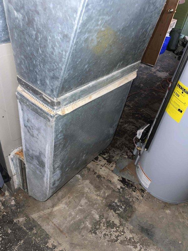 Performed comprehensive diagnostic evaluation on 20-year-old furnace system located in basement that was not operational. Inspection revealed multiple critical failures including several cracks in the heat exchanger, blower motor with oil leakage, and failed gas valve. Due to the age of the equipment and severity of the compromised components, particularly the cracked heat exchanger which poses safety concerns, provided estimate for complete furnace replacement system. Thermostat confirmed operational with proper power supply.