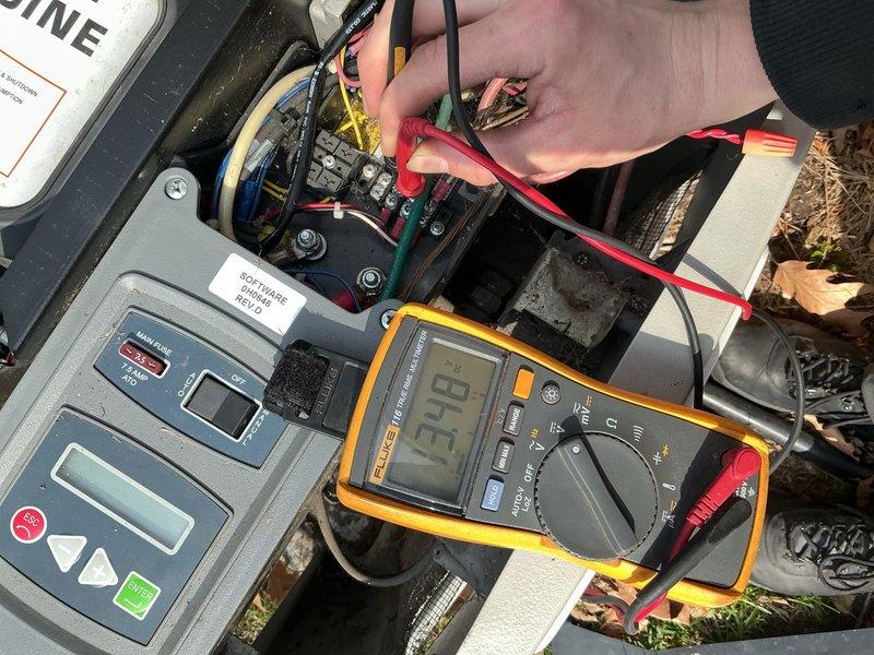 Responded to no-start condition on 16-year-old Bryant generator following utility power outage. Performed electrical diagnostics using digital multimeter, measuring voltage at control board terminals and disconnect switch. Testing revealed low voltage reading of 13.18-13.73 volts at critical electrical components, indicating insufficient battery power to initiate automatic transfer switch and engine start sequence. Identified failed or discharged battery as root cause preventing generator from activating during power loss event.