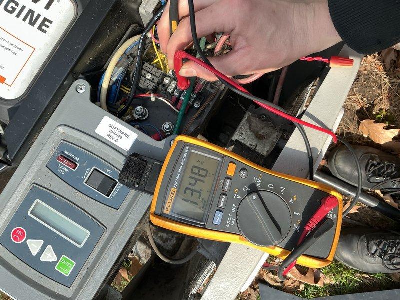 Responded to no-start condition on 16-year-old Bryant generator following utility power outage. Performed electrical diagnostics using digital multimeter, measuring voltage at control board terminals and disconnect switch. Testing revealed low voltage reading of 13.18-13.73 volts at critical electrical components, indicating insufficient battery power to initiate automatic transfer switch and engine start sequence. Identified failed or discharged battery as root cause preventing generator from activating during power loss event.