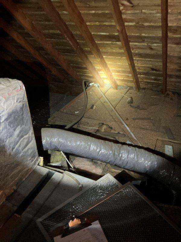 Conducted estimate for complete air conditioning system replacement at residential single-family home. Inspected existing 10-year-old system components located in attic space, including air handler unit, ductwork configuration, and plenum connections. Documented current installation featuring insulated flex duct runs, vertical supply plenum with reflective wrap insulation, and existing support structure. Evaluated attic access conditions, workspace constraints, and structural framing for new equipment installation. Photographed existing HVAC infrastructure including duct connections, insulation materials, and equipment positioning to assess replacement requirements and determine proper sizing for new system components.