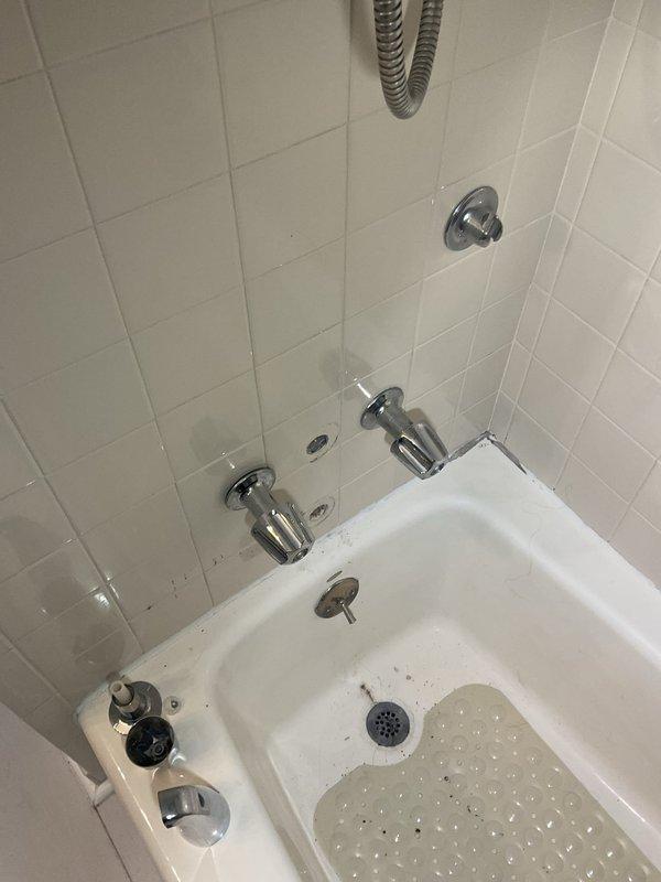 Responded to a shower diverter failure in a first-floor bathroom of a 50-year-old home where a previous replacement attempt had been unsuccessful and the connection was damaged. Upon arrival, assessed the existing chrome diverter valve system and tub/shower plumbing configuration with dual faucet handles and multiple wall-mounted fixtures. Removed the failed diverter assembly and inspected the valve body and internal connections, finding deteriorated threading and compromised seating surfaces typical of aged plumbing systems. Replaced the complete diverter valve assembly with a compatible unit, ensuring proper threading engagement and seal integrity. Tested the diverter mechanism for smooth operation between tub spout and shower head functions, verified water flow distribution, and checked all connections for leaks under full pressure. Restored full functionality to the shower diverter system, eliminating the issue that had progressively worsened over the previous weeks.