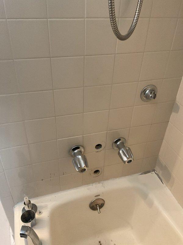 Responded to a shower diverter failure in a first-floor bathroom of a 50-year-old home where a previous replacement attempt had been unsuccessful and the connection was damaged. Upon arrival, assessed the existing chrome diverter valve system and tub/shower plumbing configuration with dual faucet handles and multiple wall-mounted fixtures. Removed the failed diverter assembly and inspected the valve body and internal connections, finding deteriorated threading and compromised seating surfaces typical of aged plumbing systems. Replaced the complete diverter valve assembly with a compatible unit, ensuring proper threading engagement and seal integrity. Tested the diverter mechanism for smooth operation between tub spout and shower head functions, verified water flow distribution, and checked all connections for leaks under full pressure. Restored full functionality to the shower diverter system, eliminating the issue that had progressively worsened over the previous weeks.