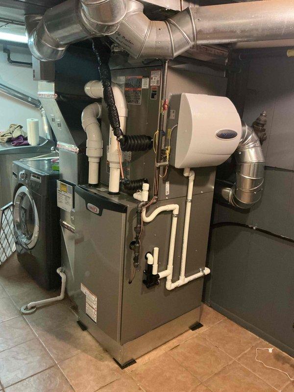 Completed full HVAC system installation including a 110,000 BTU gas furnace with right-side configuration and 4-ton air conditioning unit in residential mechanical room. Installed Aprilaire humidifier mounted on furnace, new thermostat, and 20x25x1 filter base with 600 CFM airflow capacity. Ran new PVC venting and drainage lines, connected copper refrigerant lines, and installed metallic ductwork with proper segmented joints. Mounted exterior electrical disconnect and established utility meter connections on exterior brick wall. Reconnected all necessary gas, electrical, and plumbing connections. Obtained mechanical and electrical permits and remeasured return air for proper system sizing. System qualified for utility rebate program and passed all code inspections.